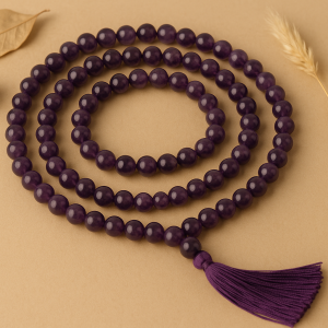 Amethyst japa mala with 108+1 beads placed on beige background with natural light – handcrafted by Vedoorja Jaipur